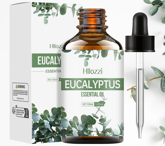 Glass bottle labeled Eucalyptus Pure Essential Oil by Hllozzi with dropper next to eucalyptus leaves and amber oil