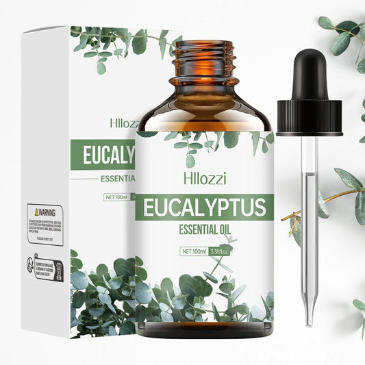 Glass bottle labeled Eucalyptus Pure Essential Oil by Hllozzi with dropper next to eucalyptus leaves and amber oil