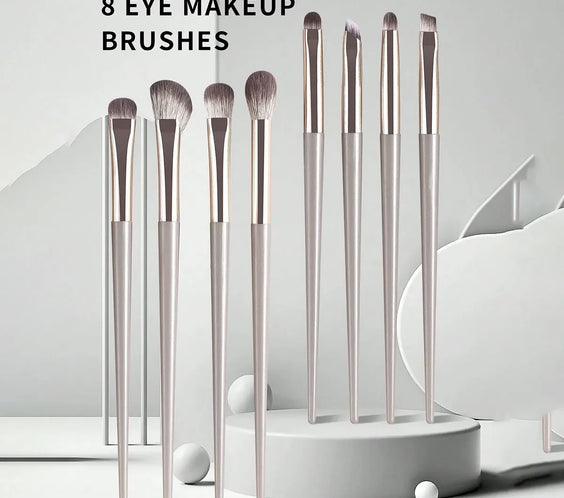 Champagne Wool Eye Brush Set 8 wool-fiber eye brushes with champagne silver plastic handles arranged compactly for travel