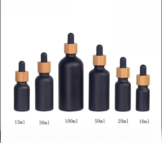 Matte Black Frosted Oil Bottle with frosted glass body bamboo ring and rubber dropper cap in multiple sizes