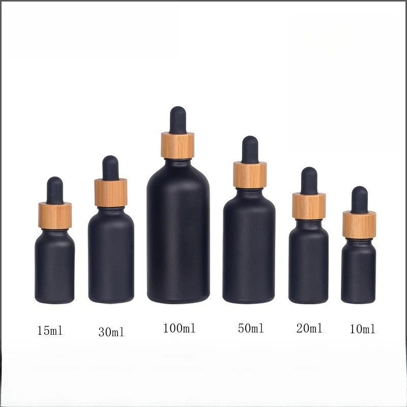 Matte Black Frosted Oil Bottle with frosted glass body bamboo ring and rubber dropper cap in multiple sizes