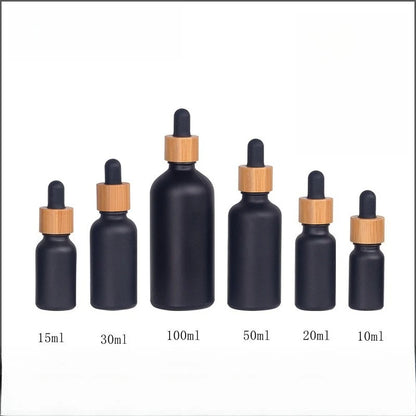 Matte Black Frosted Oil Bottle with frosted glass body bamboo ring and rubber dropper cap in multiple sizes
