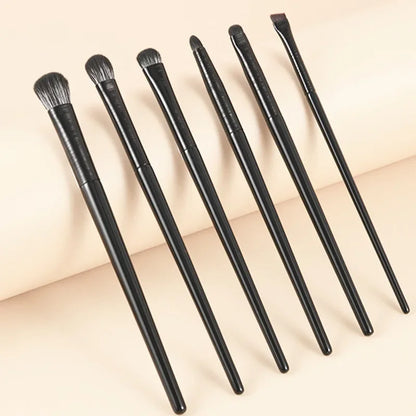 6PCS Wool Fiber Eye Brush Set six brushes with wool fiber bristles and plastic handles laid flat